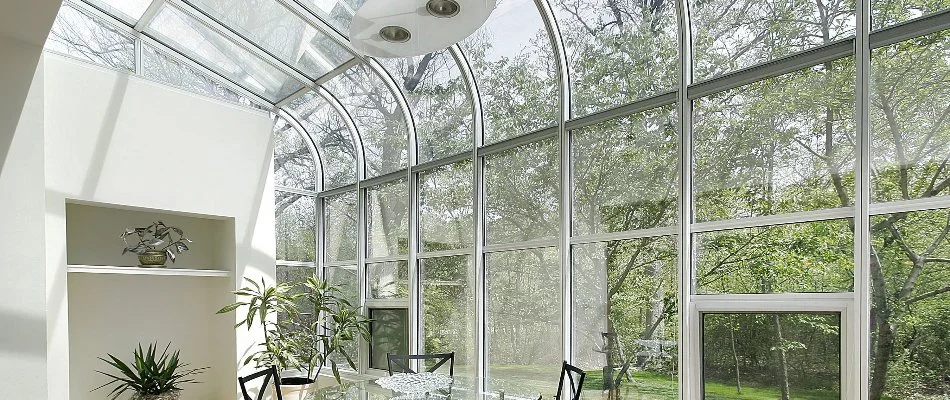 A glass room in Wimauma, FL, with large windows and plants.