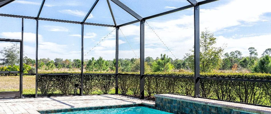 A screen room on a property in Wimauma, FL, with a pool.