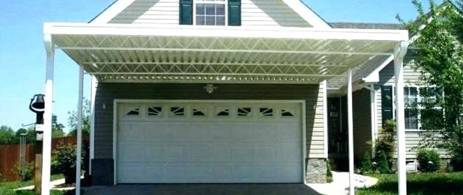 A carport installed in front of a garage for a home in Brandon, FL.